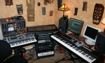 The studio as of February 2005. Left to right: MOTM modular synth, Alesis Andromeda, TASCAM US-2400 fader controller, rack gear, Studiologic SL-1100 controller, monitors for Apple PowerMac G5 running Logic and PC running GigaStudio. 